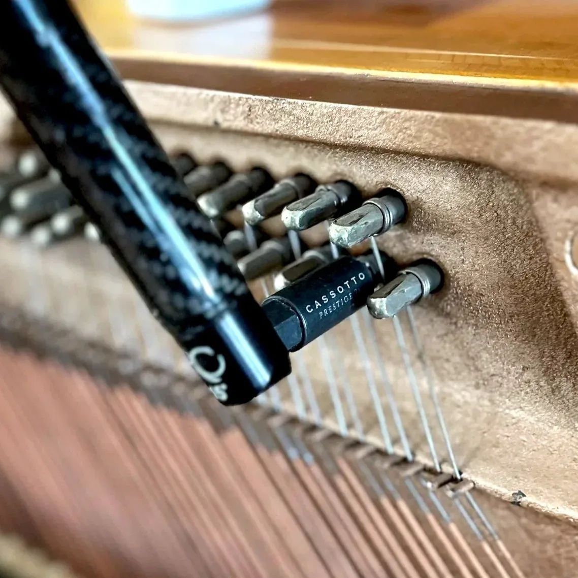 A Cassotto lever with a Prestige tip seated on a tuning pin